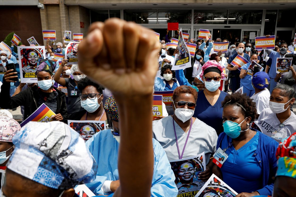 Members of the 1199SEIU union, the nation's largest healthcare workers' union, take part in a vigil and walkout action at Brookdale Hospital Medical Center in a protest against racial inequality in Brooklyn, New York