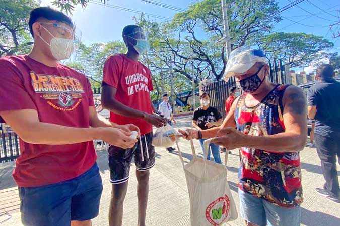 Bismarck-Lina-and-Malick-Diouf-distributing-goods-in-a-community-pantry-in-UP-Diliman