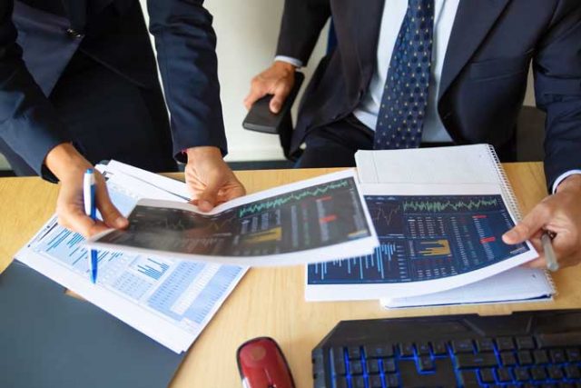 investor-trader-discussing-statistic-data-holding-papers-with-financial-charts-pen-cropped-shot-broker-job-trading-concept