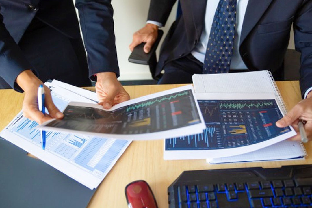 investor-trader-discussing-statistic-data-holding-papers-with-financial-charts-pen-cropped-shot-broker-job-trading-concept