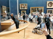 Mona Lisa left unharmed but smeared in cream in climate protest stunt