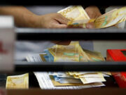 Peso edges up vs dollar ahead of US labor data