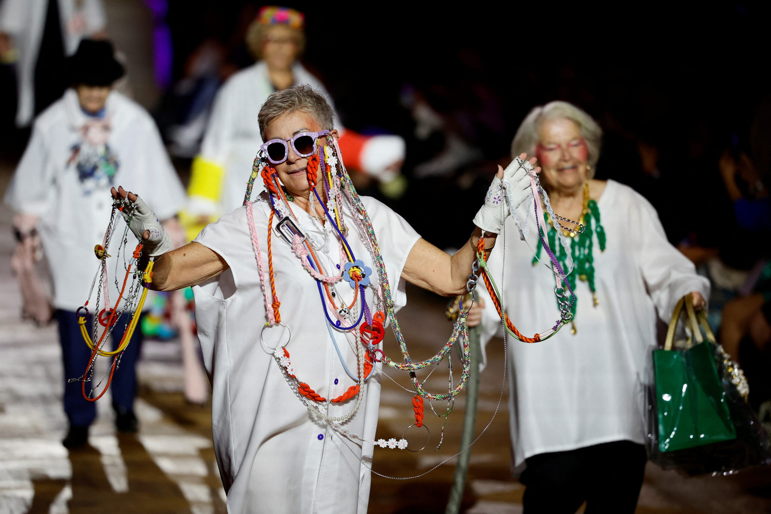 Elderly people and fashion students on catwalk to show that beauty has no age, in Paris