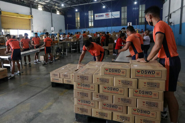 Volunteers pack relief boxes