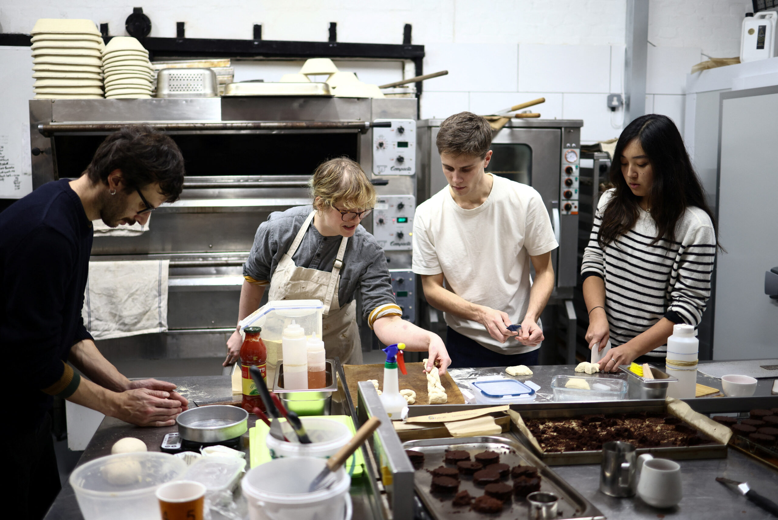 Hearth Bakery hosts ‘The People’s Oven’ communal cooking event, inviting members of the local community to use the facilities to cook their own food, in Hackney Wick, London