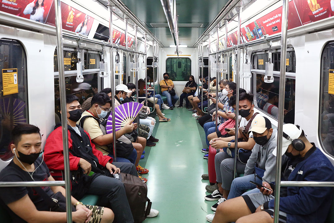 Commuters ride the Light Rail Transit