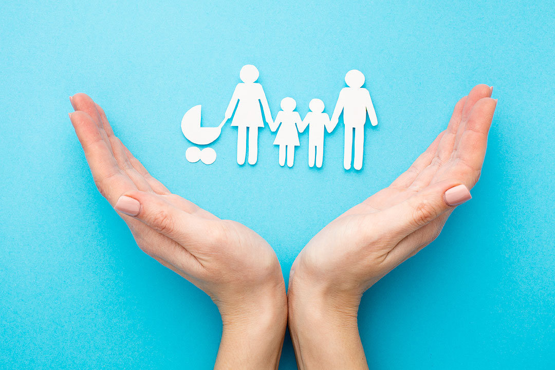 top-view-hands-with-paper-cut-family