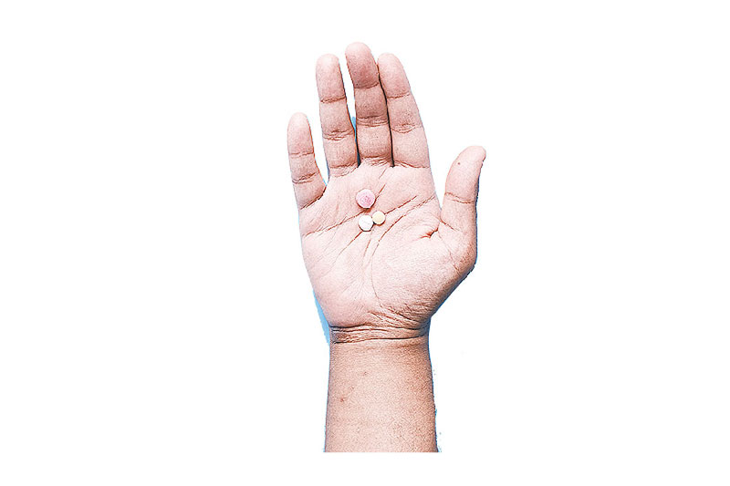 pills on palm of hand