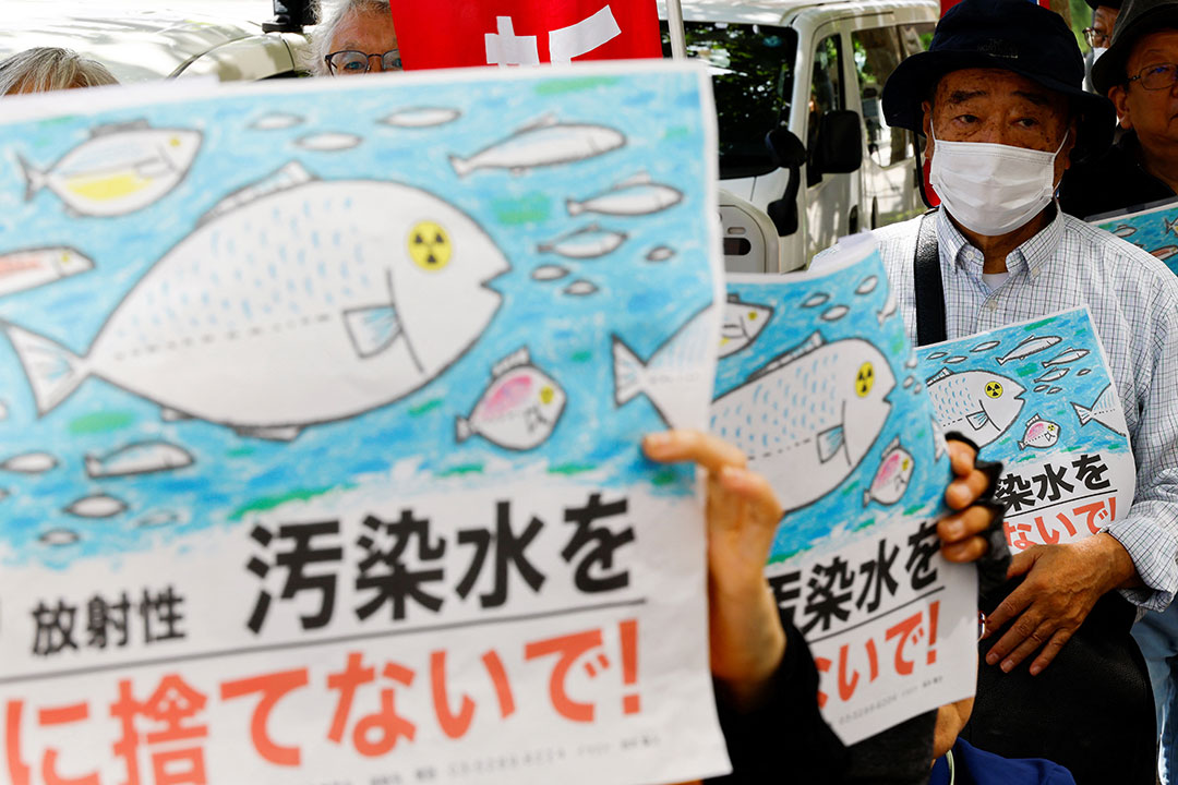 Protesters hold placards that read “No radiation contaminated water into the sea”