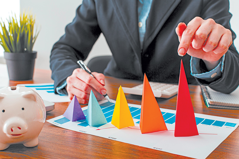 SF_front-view-businessman-with-colorful-cones-representing-growth_FREEPIK-OL