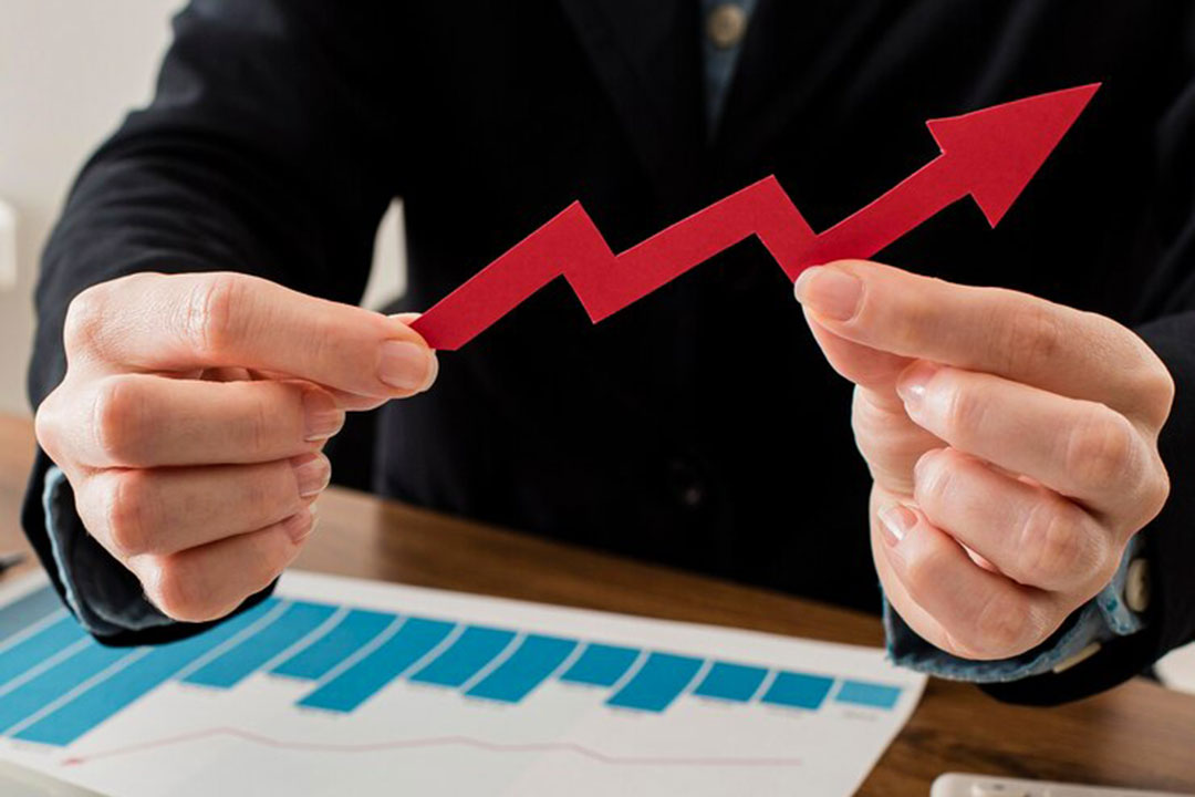 businessman-holding-growth-arrow