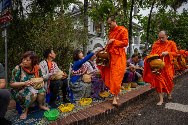Luang Prabang, Laos-monks-tourists-BLOOMBERG