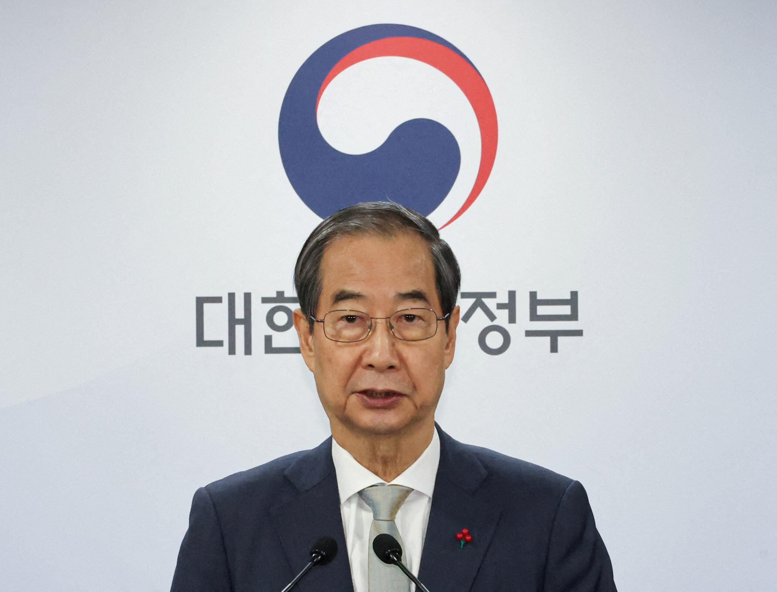 Acting South Korean President and Prime Minister Han Duck-soo delivers an address to the nation at the government complex in Seoul