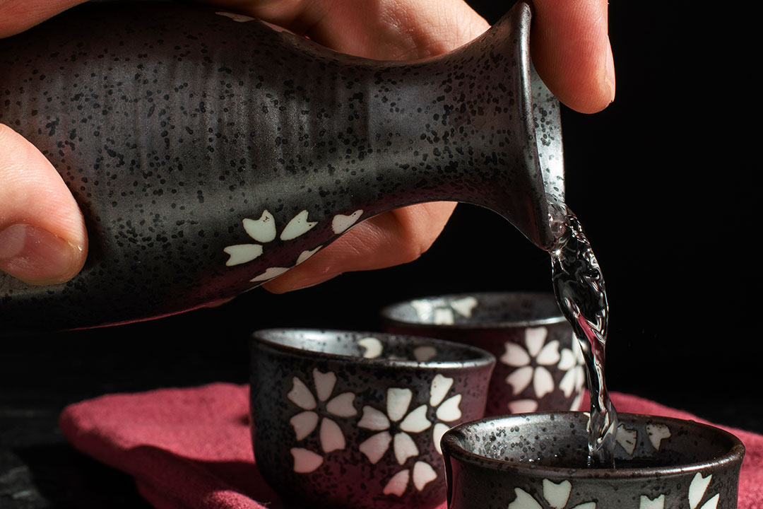 side-view-hand-pouring-sake-drink