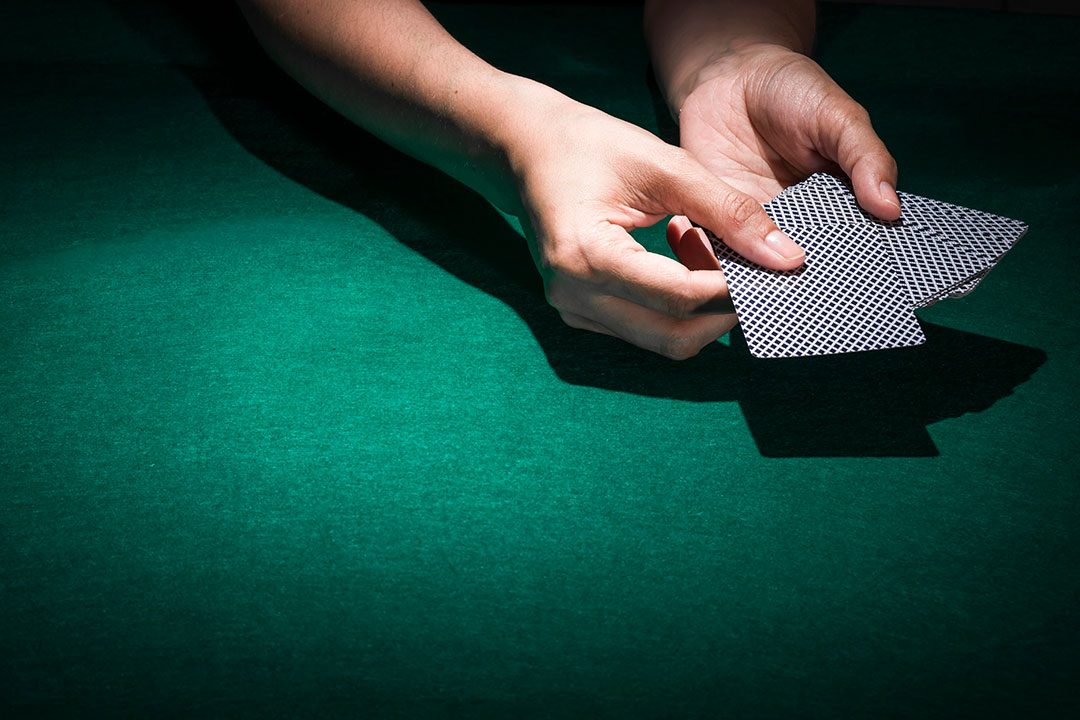 person-hand-s-holding-poker-card
