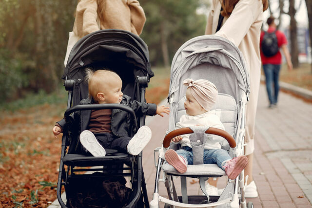 two-young-mothers-walking-autumn-park-with-carriages