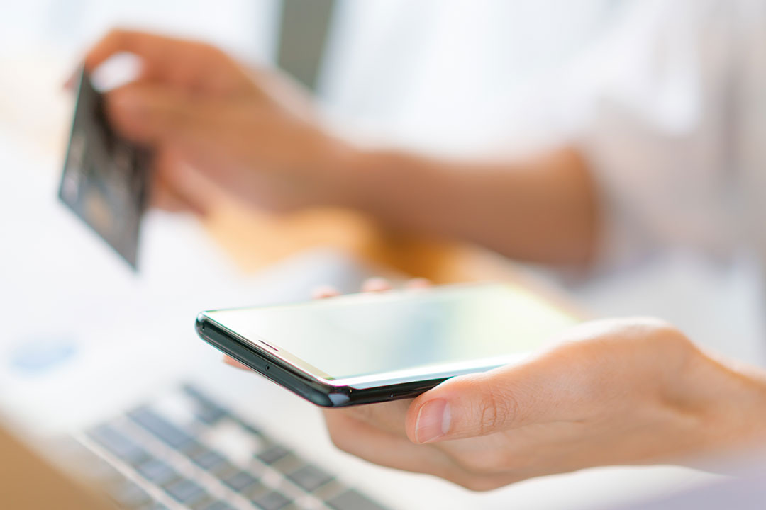 hands-holding-credit-card-using-laptop-computer-mobile-phone-online-shopping