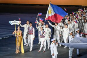 Eala carries Philippine flag with Bryan Bagunas at Southeast Asian Games in Bangkok, Thailand