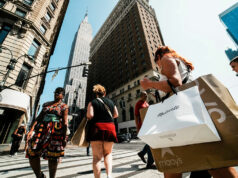 US economy to ride tax cut tailwind but faces risks