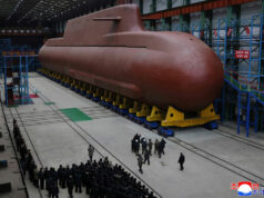 North Korea’s Kim Jong Un views submarine construction, oversees missile launch, KCNA says